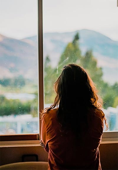 woman looking out window