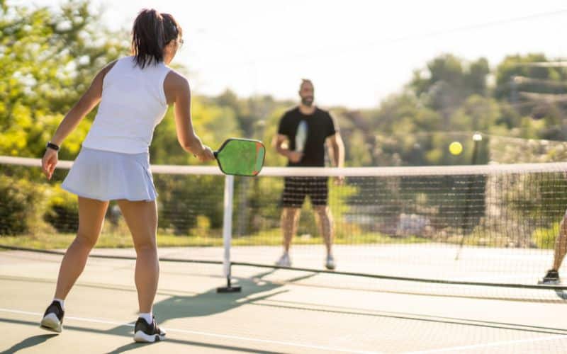 man and woman playing pickleball