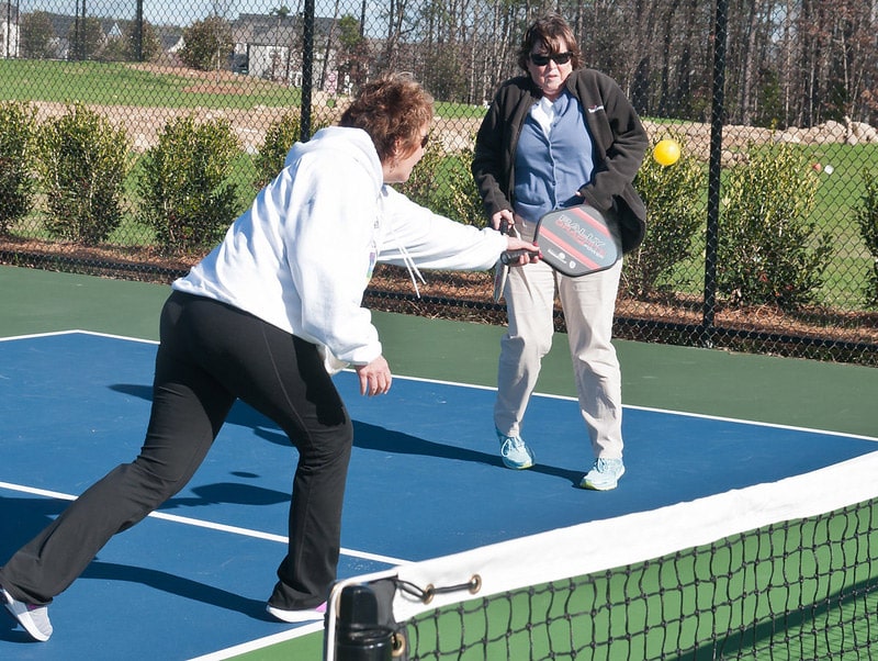 women playing pickleball