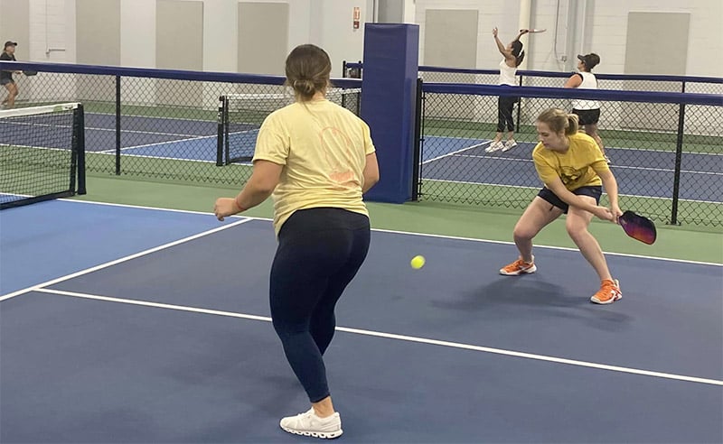 women playing pickleball