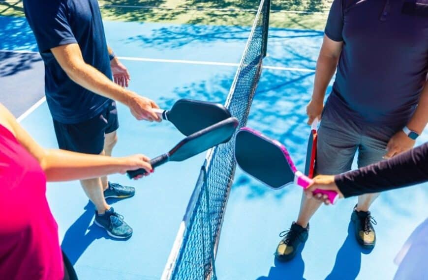 four players at pickleball court