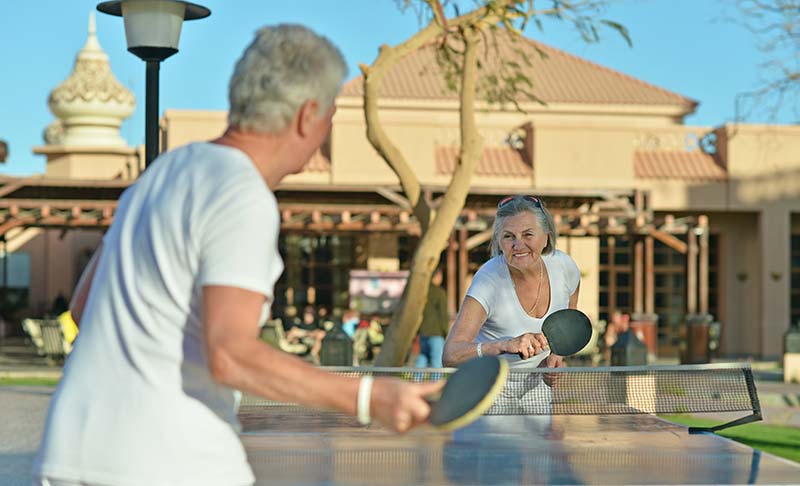 man and woman playing ping pong