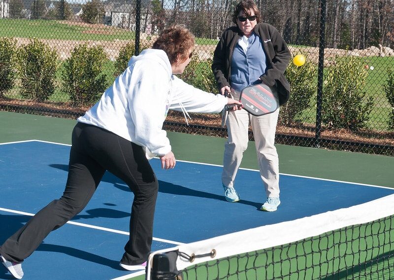 women playing pickleball