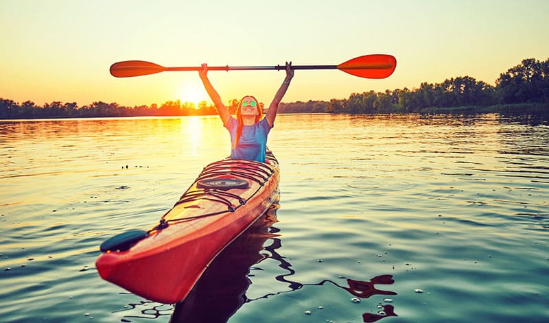 excited woman kayaking