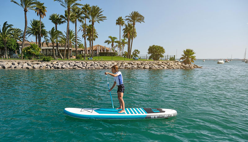 kid on paddle board in ocean