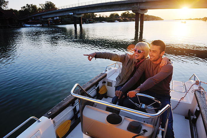 man and woman driving boat in river