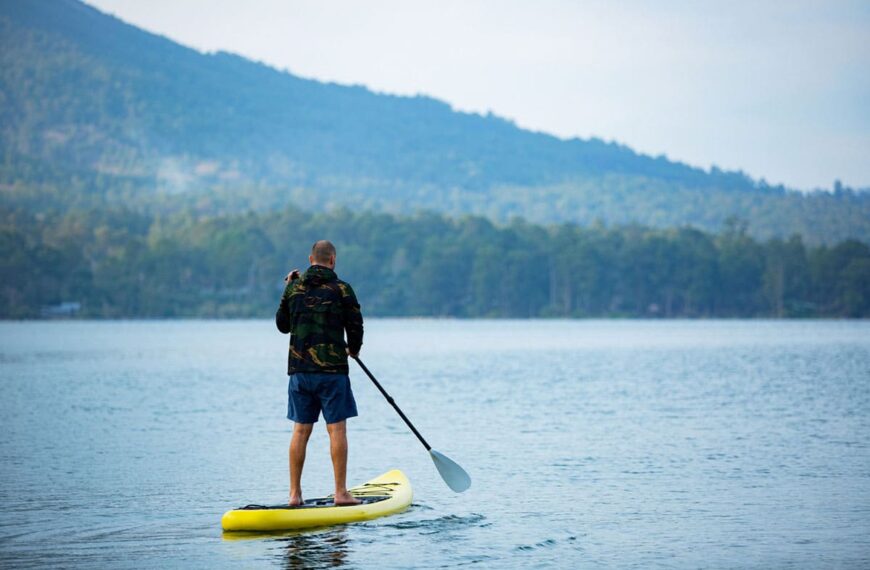 man on sup on lake