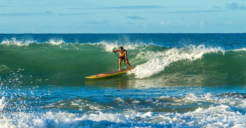 guy paddleboard surfing