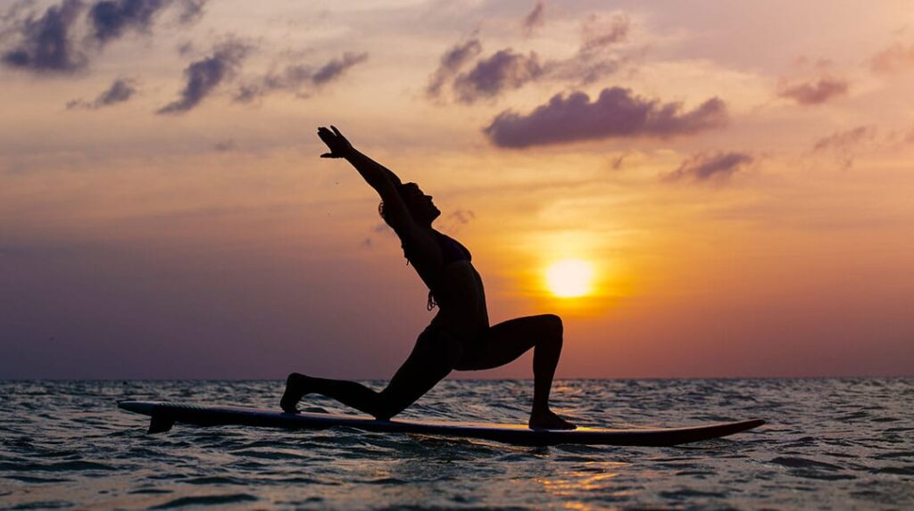 sup yoga at sunset