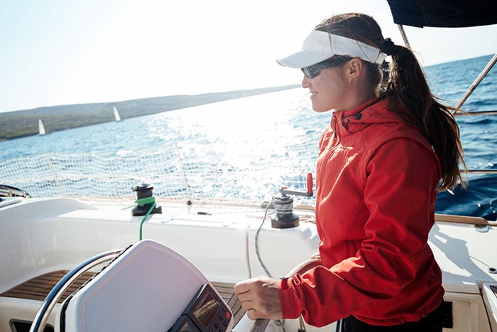 woman driving sailboat