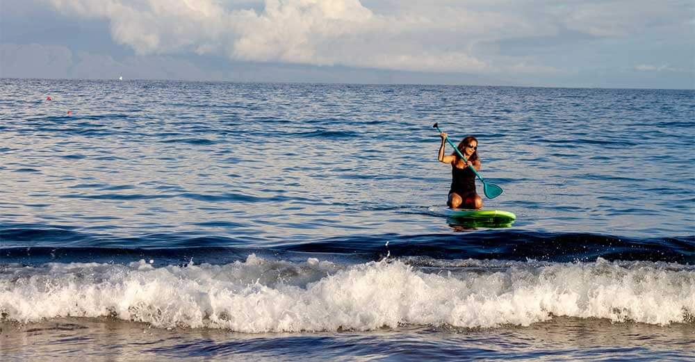 woman kneeling on SUP