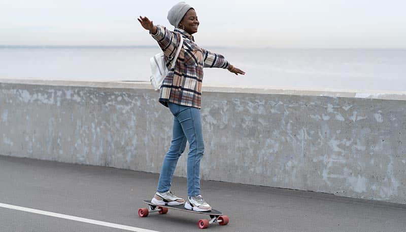 woman riding longboard