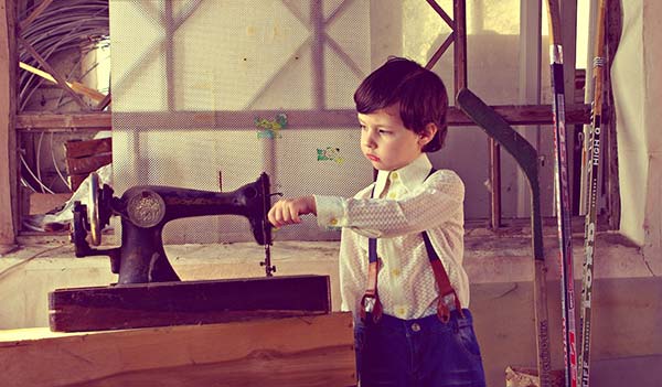 boy with vintage sewing machine