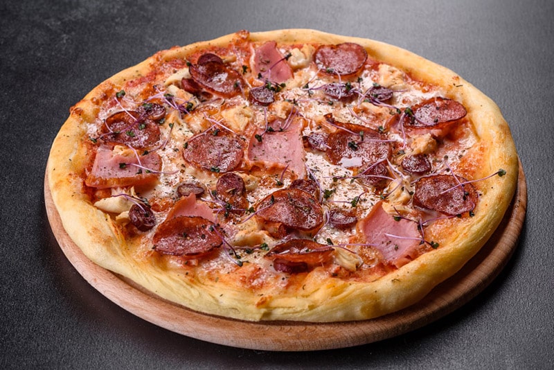 pizza with tomatoes, salami and bacon