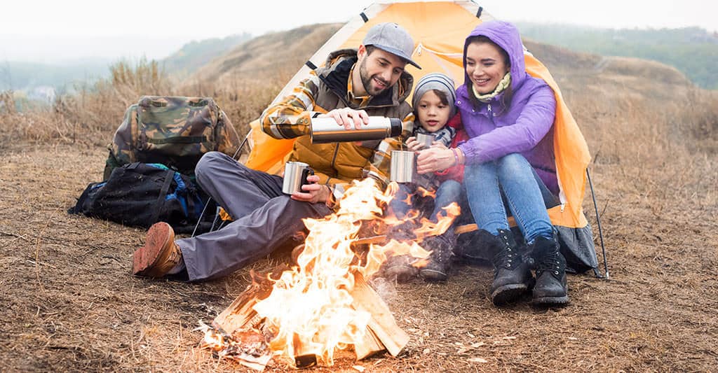 family camping at campfire