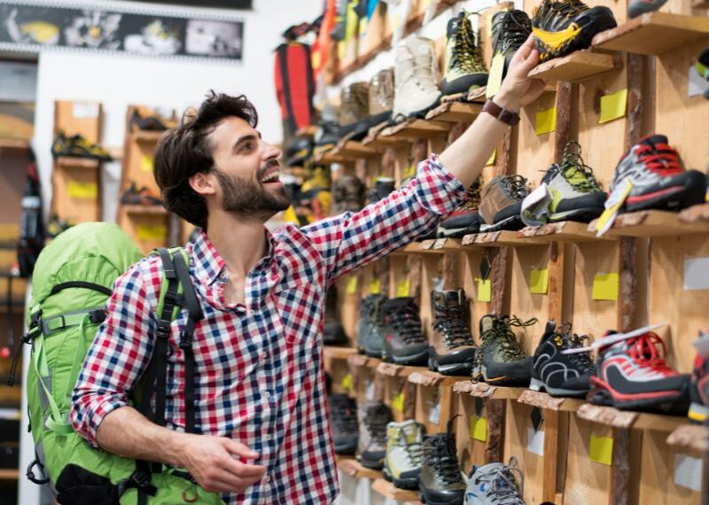 guy looking at hiking shoes