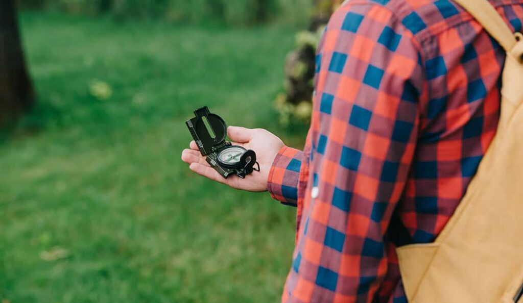 hiker using compass