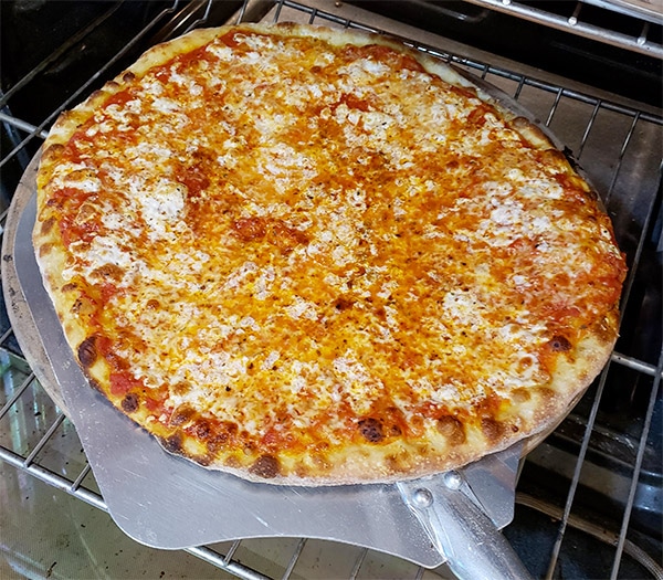 using pizza peel to put pizza on stone