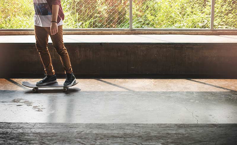 legs of a skater riding through tunnel