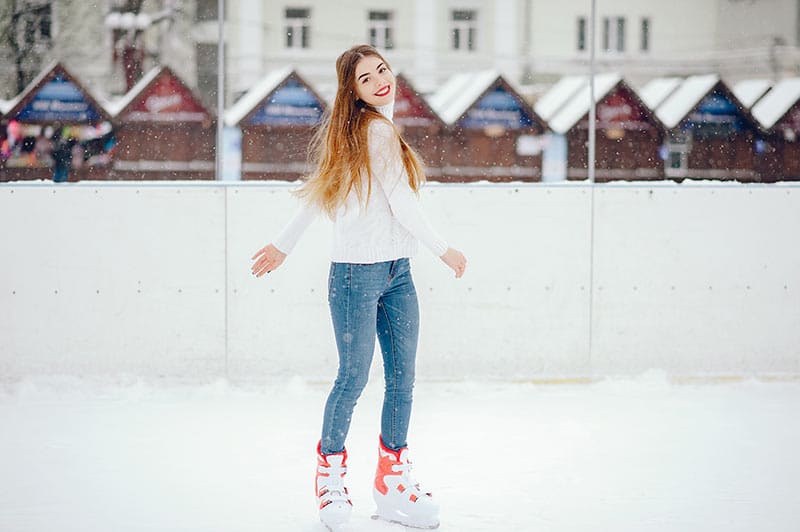 woman skates on outdoor ice rink